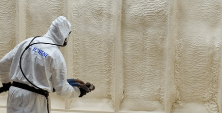 person spraying insulation foam
